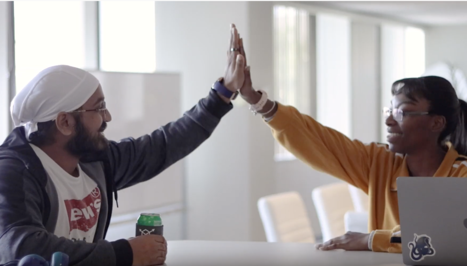 two people giving each other a high five